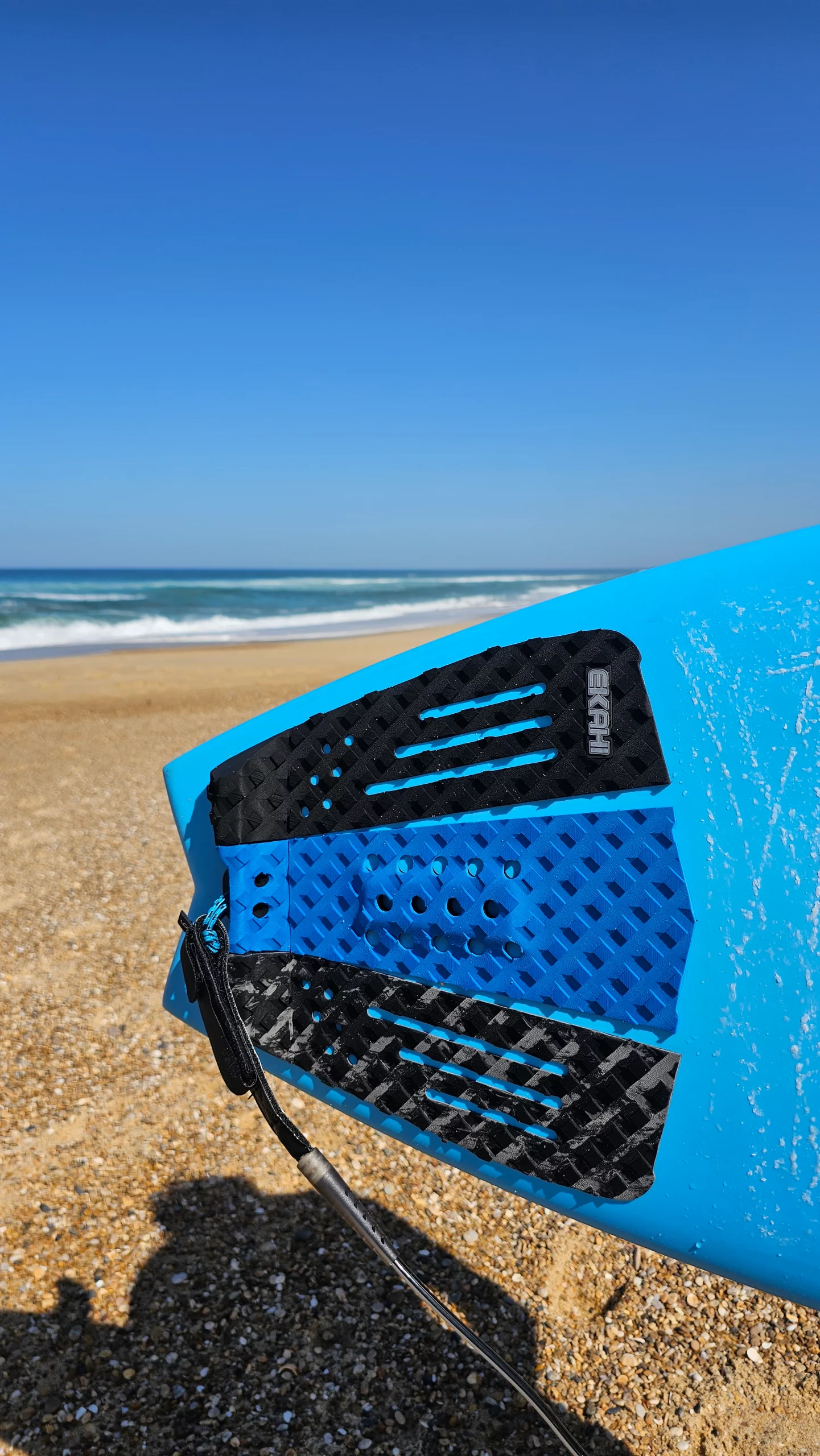 Top view of a Squash Black/blue/marble on a Blue Channels carbon surfboard
