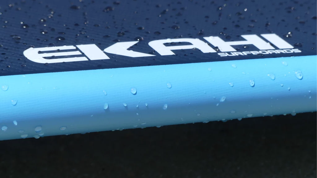 Close-up of the Ekahi logo on a blue 53 carbon surfboard
