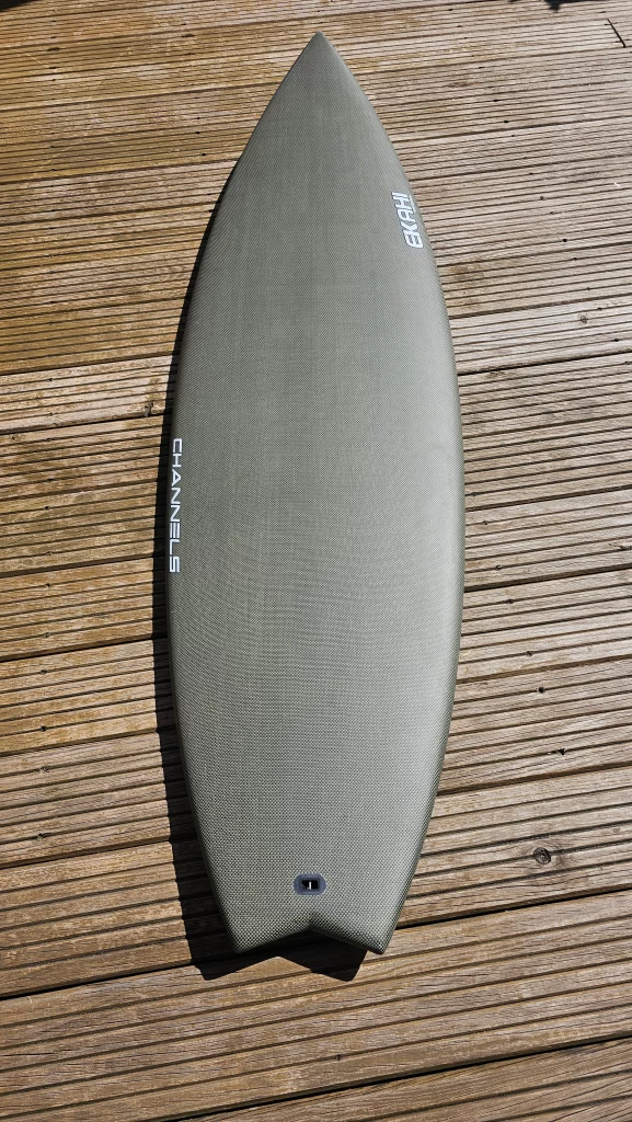 View of a ekahi carbon kevlar Channels carbon surfboard 5'8.