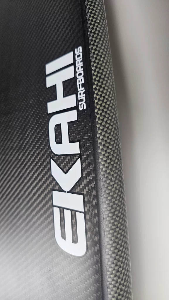 Bottom view of the EKAHI logo on a a ekahi carbon kevlar Channels carbon surfboard 5'8.