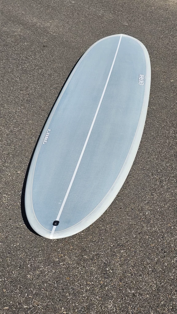 Ekahi Long surfboard lying on the pavement, top deck view with pinline