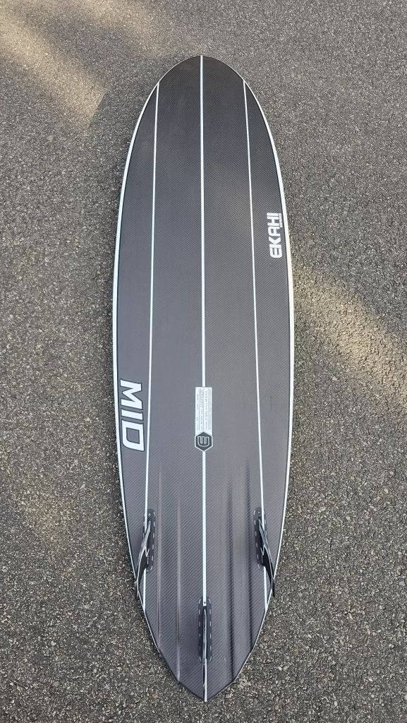 Ekahi Mid Bitume carbon surfboard, white deck, bottom view