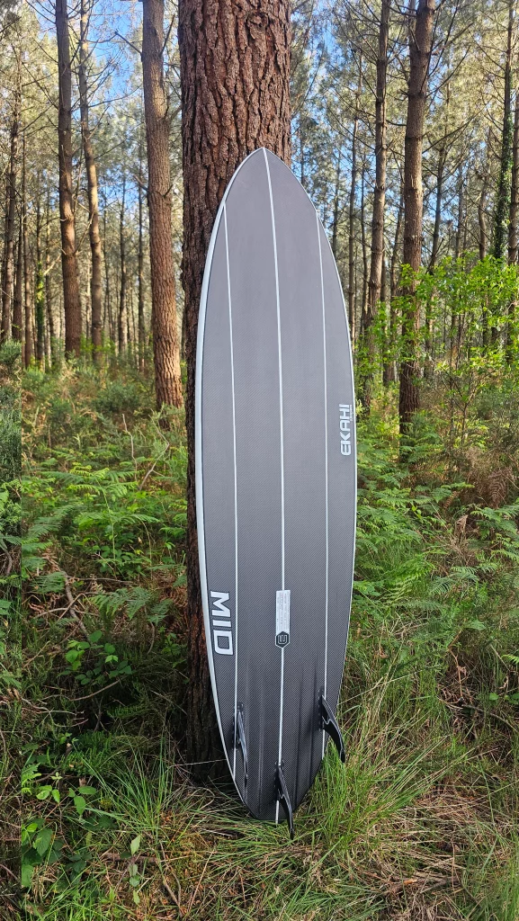Ekahi Mid Bois carbon surfboard, white deck, bottom view