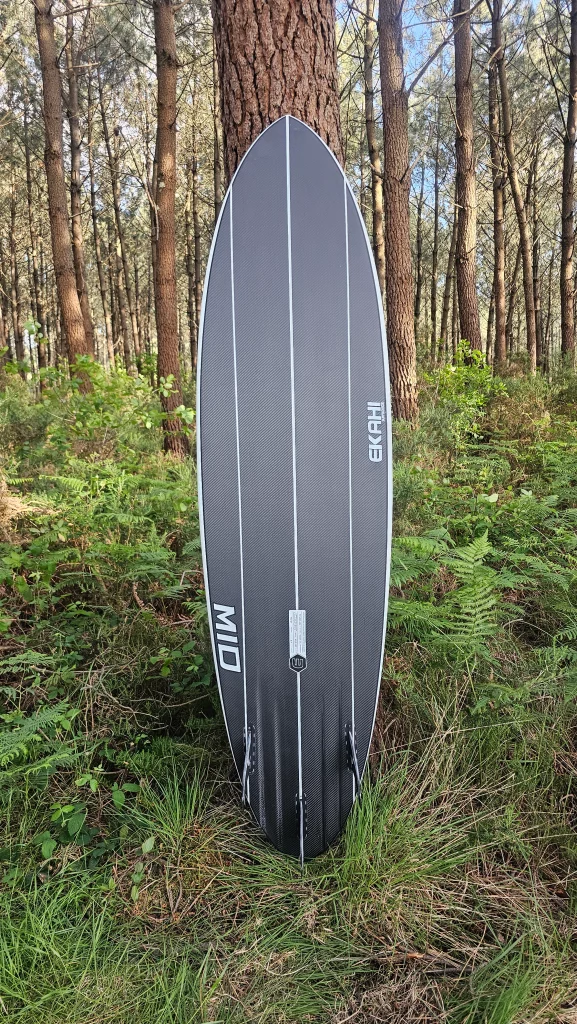 Ekahi Mid Bois carbon surfboard, white deck, bottom view