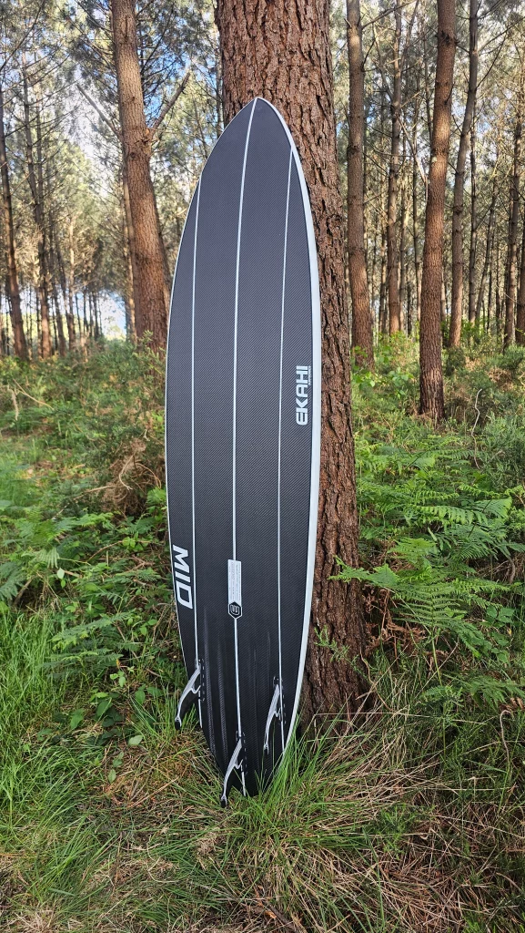 Ekahi Mid Bois carbon surfboard, white deck, bottom view
