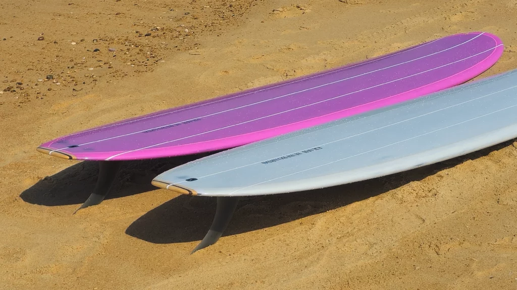Top view of the Ekahi pearl white and pink Single longboard.