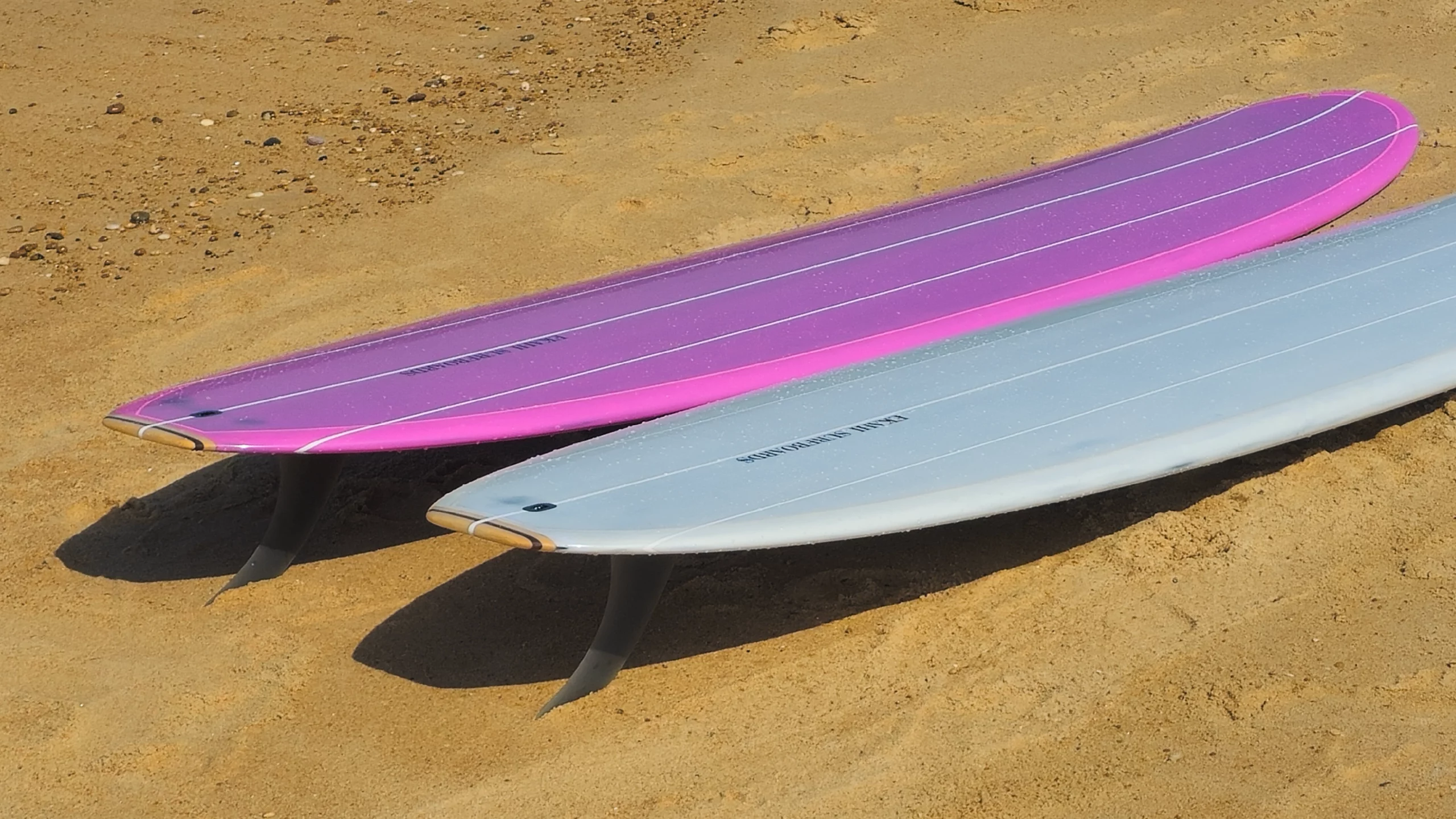 Top view of the Ekahi pearl white and pink Single longboard.