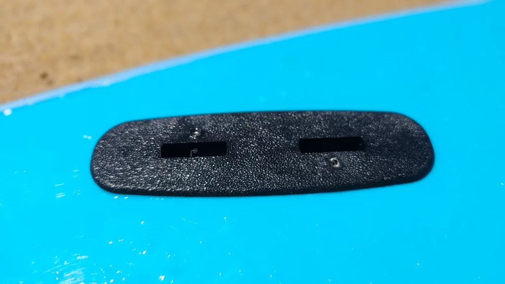 Close-up of a recessed carry handle on a blue Ekahi soft-top surfboard