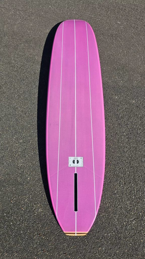 Ekahi Single Bitume carbon surfboard, pink deck, bottom view