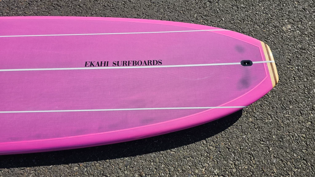 Ekahi Single Bitume carbon surfboard, pink deck, top deck view
