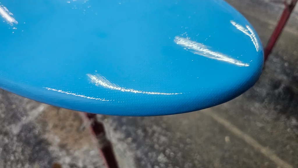 View of the hot coat of the carbon fiber with a blue tinted resin.