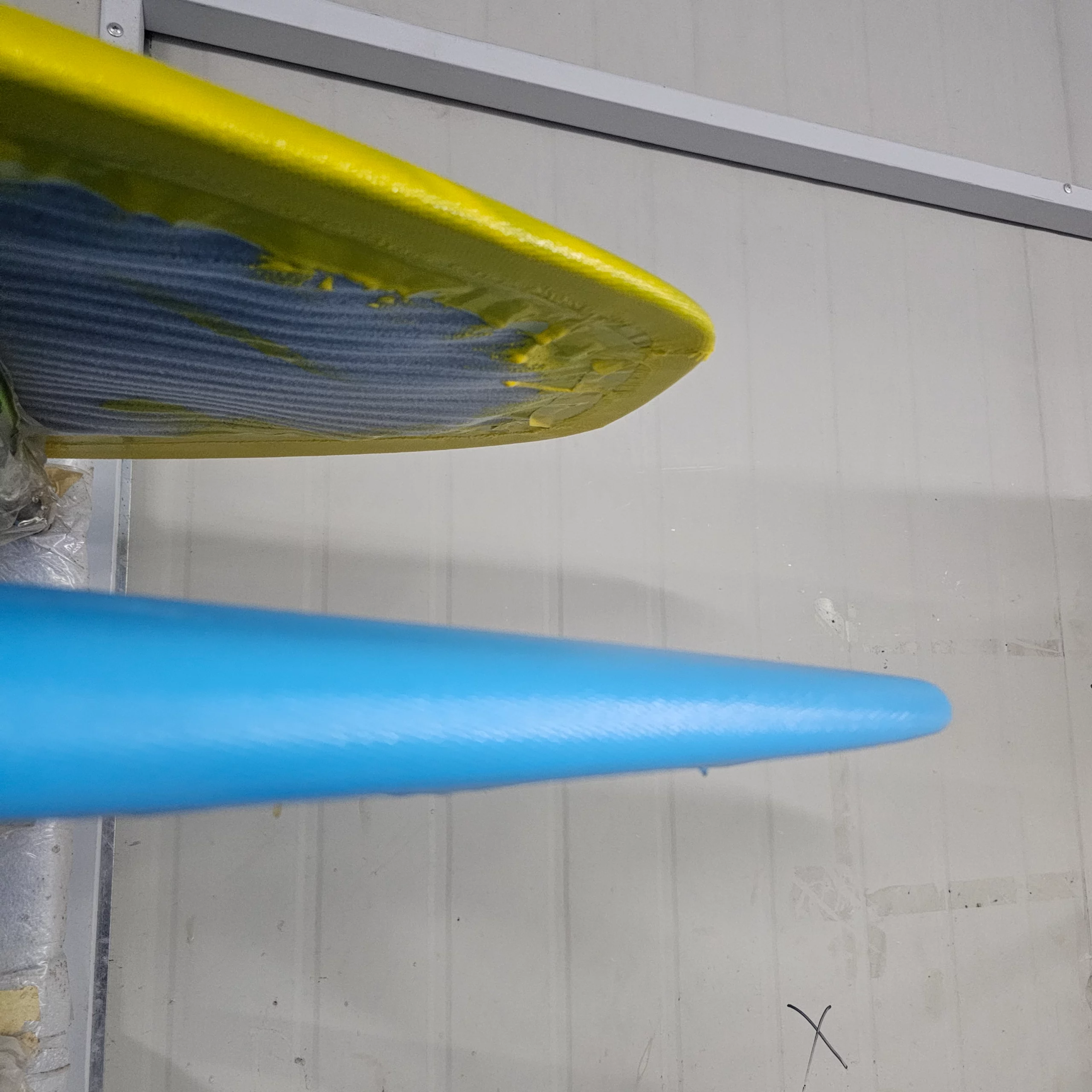 View of the hot coat of the carbon fiber with a blue tinted resin and a yellow tinted resin.