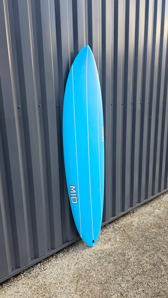 Ekahi Mid carbon surfboard, blue deck, top deck view