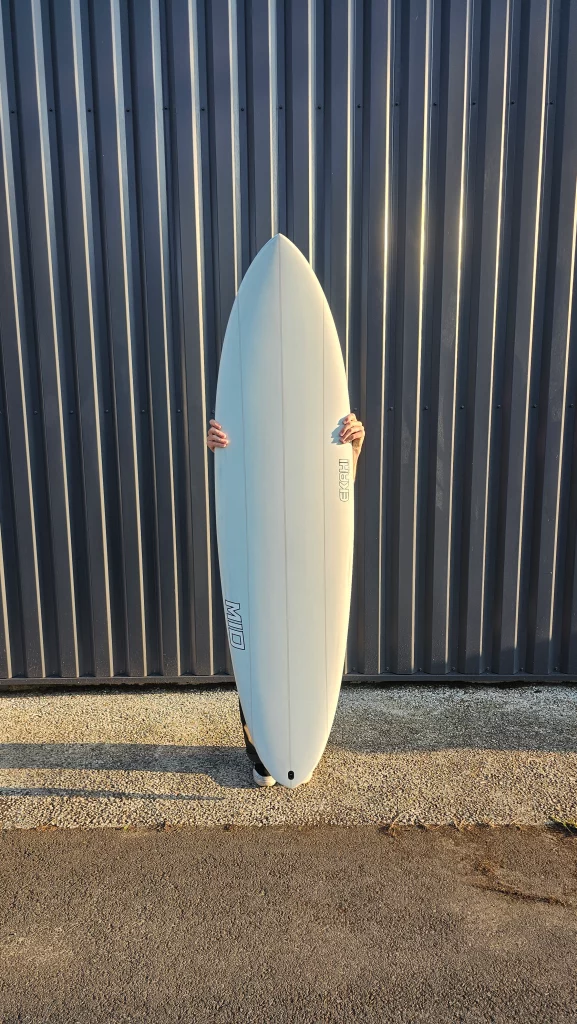 Ekahi Mid carbon surfboard, white deck, top deck view